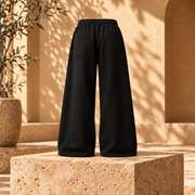 Buzo baggy liso algodón nacional negro vista espalda fondo beige mediterráneo